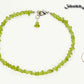 Natural Peridot Crystal Chip Anklet beside a dime