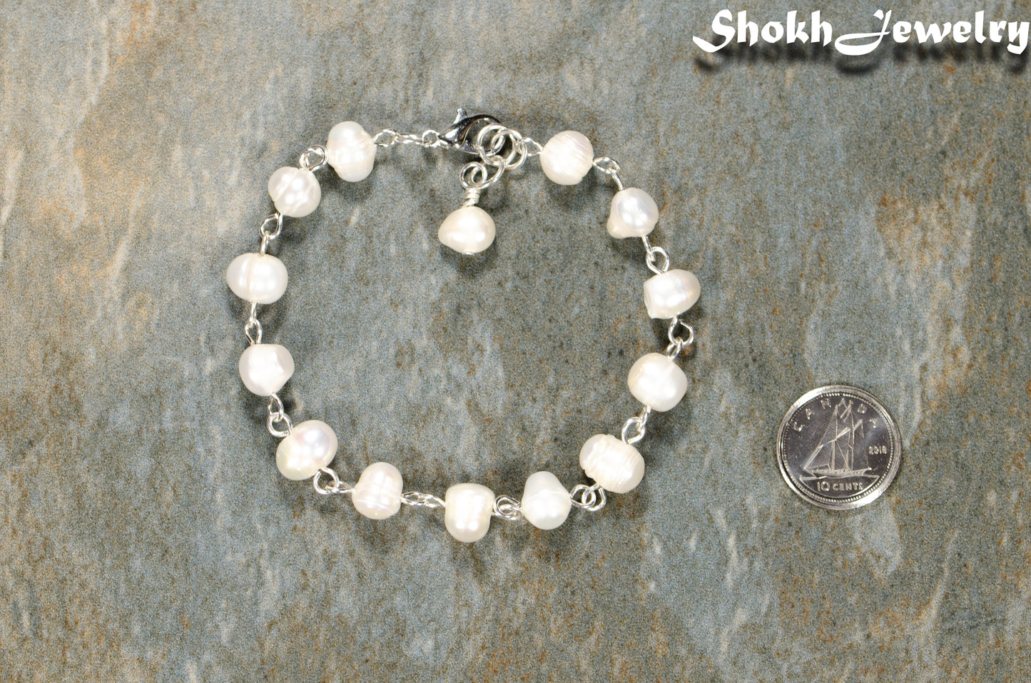 Handmade Freshwater Pearls Link Chain Bracelet beside a dime