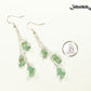 Long Silver Plated Chain and Green Aventurine Crystal Chip Earrings beside a dime