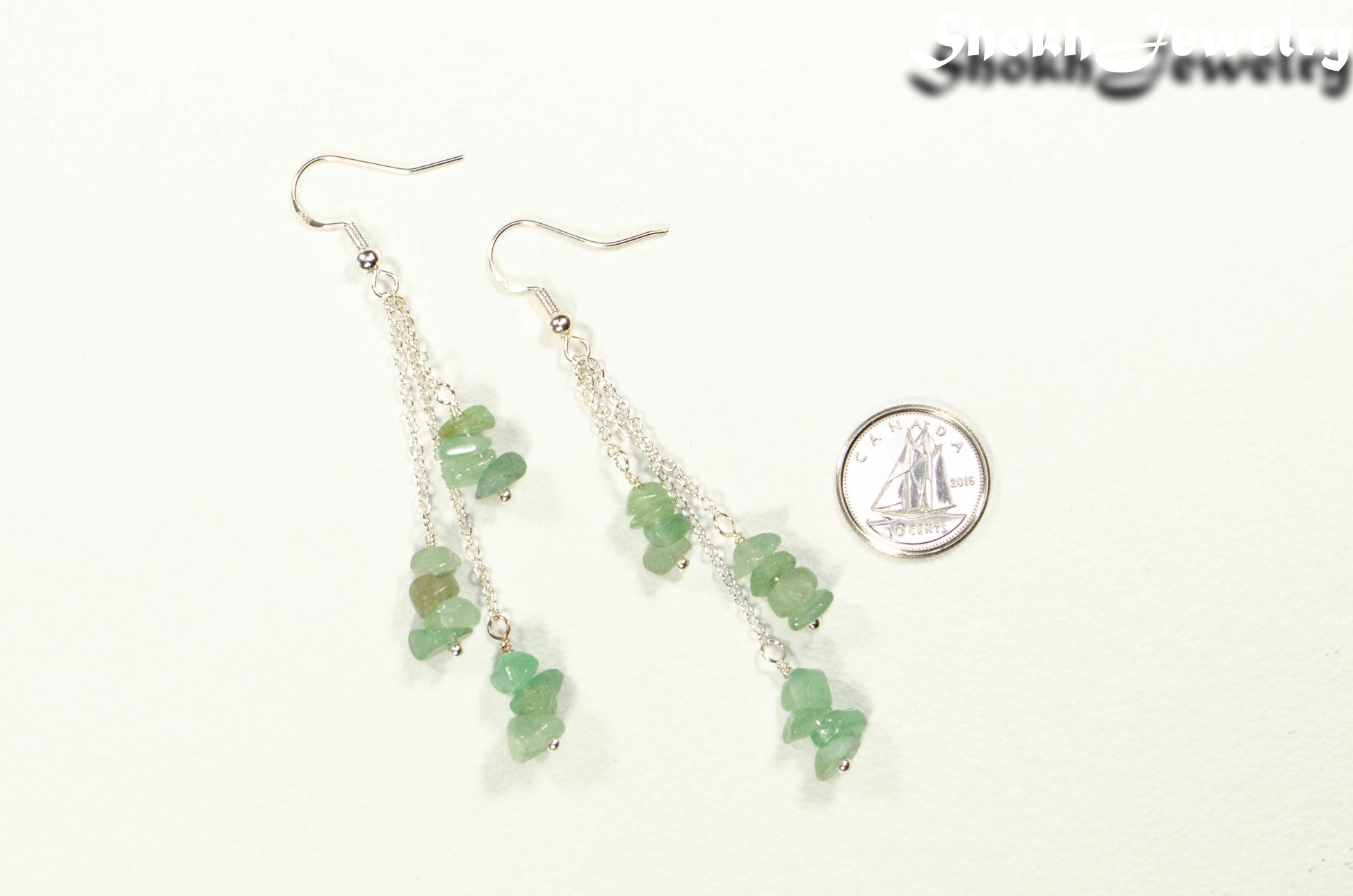 Long Silver Plated Chain and Green Aventurine Crystal Chip Earrings beside a dime