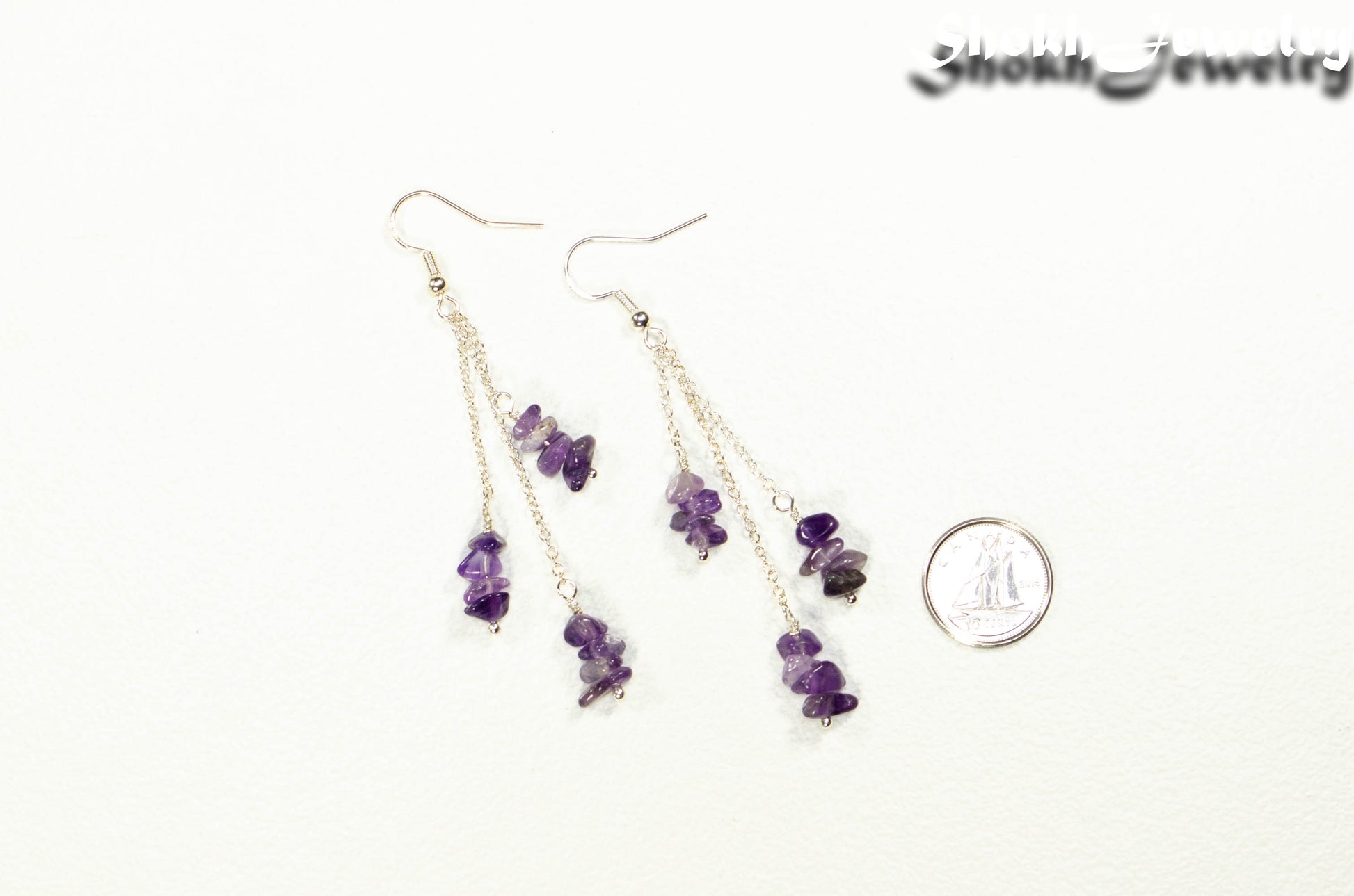 Long Silver Plated Chain and Amethyst Crystal Chip Earrings beside a dime