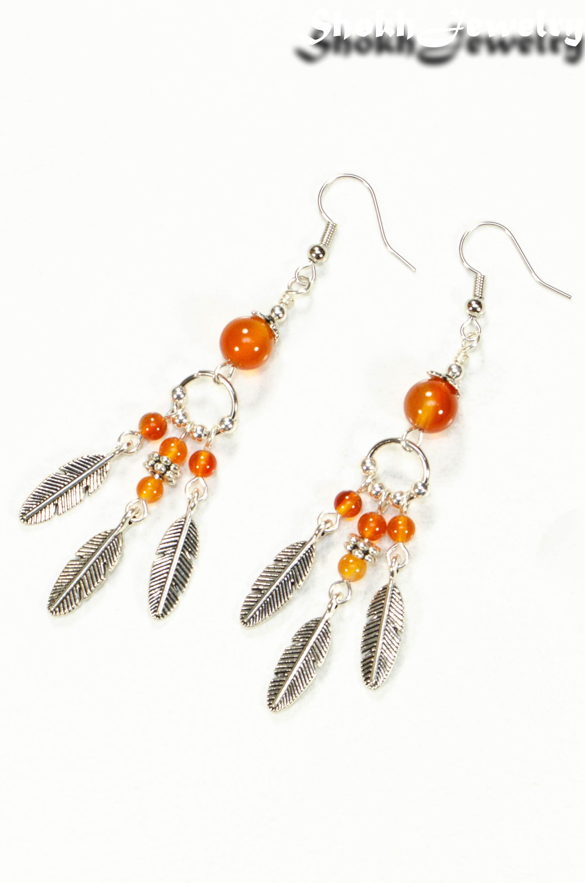 Top view of Statement Carnelian Crystal And Feather Earrings.