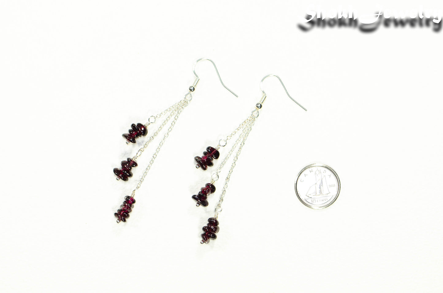 Long Silver Plated Chain and Garnet Crystal Chip Earrings beside a dime