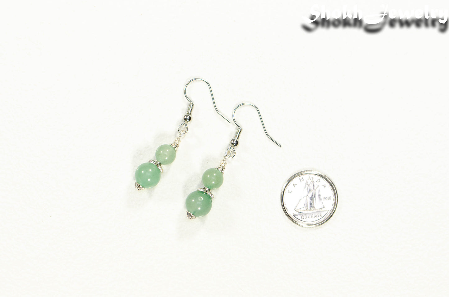 Small Green Aventurine Crystal Earrings beside a dime