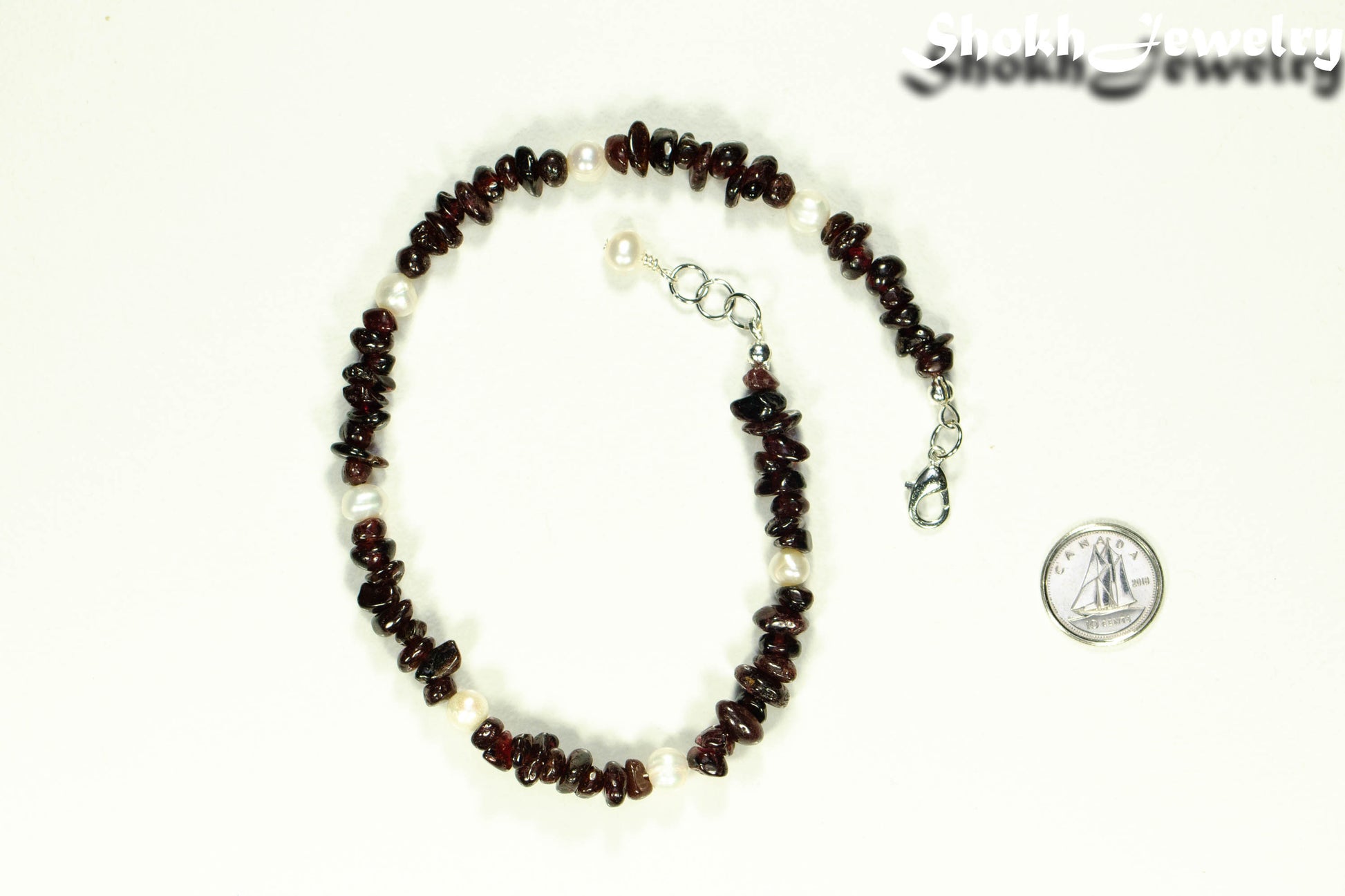 Natural Garnet Crystal Chip and Pearl Anklet beside a dime.