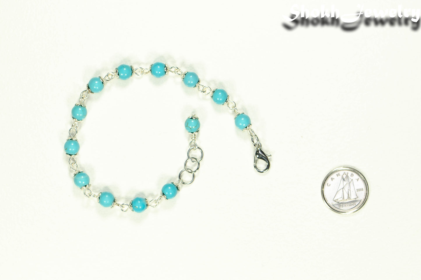 6mm Turquoise Howlite Bracelet beside a dime.