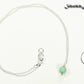 Dainty Mint Green Quartz Choker Necklace beside a dime