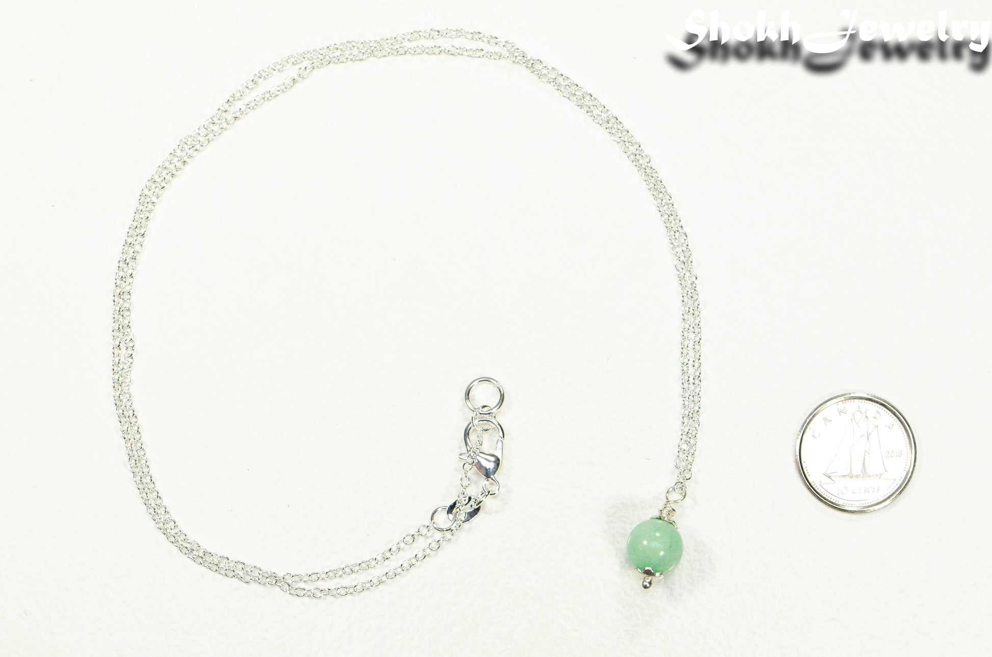 Dainty Mint Green Quartz Choker Necklace beside a dime