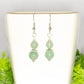 Small Green Aventurine Crystal Earrings on a tea cup