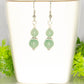 Small Green Aventurine Crystal Earrings on a tea cup