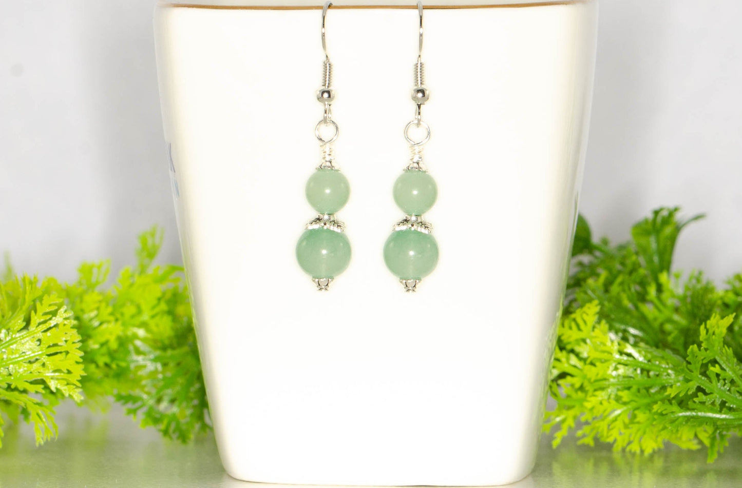 Small Green Aventurine Crystal Earrings on a tea cup