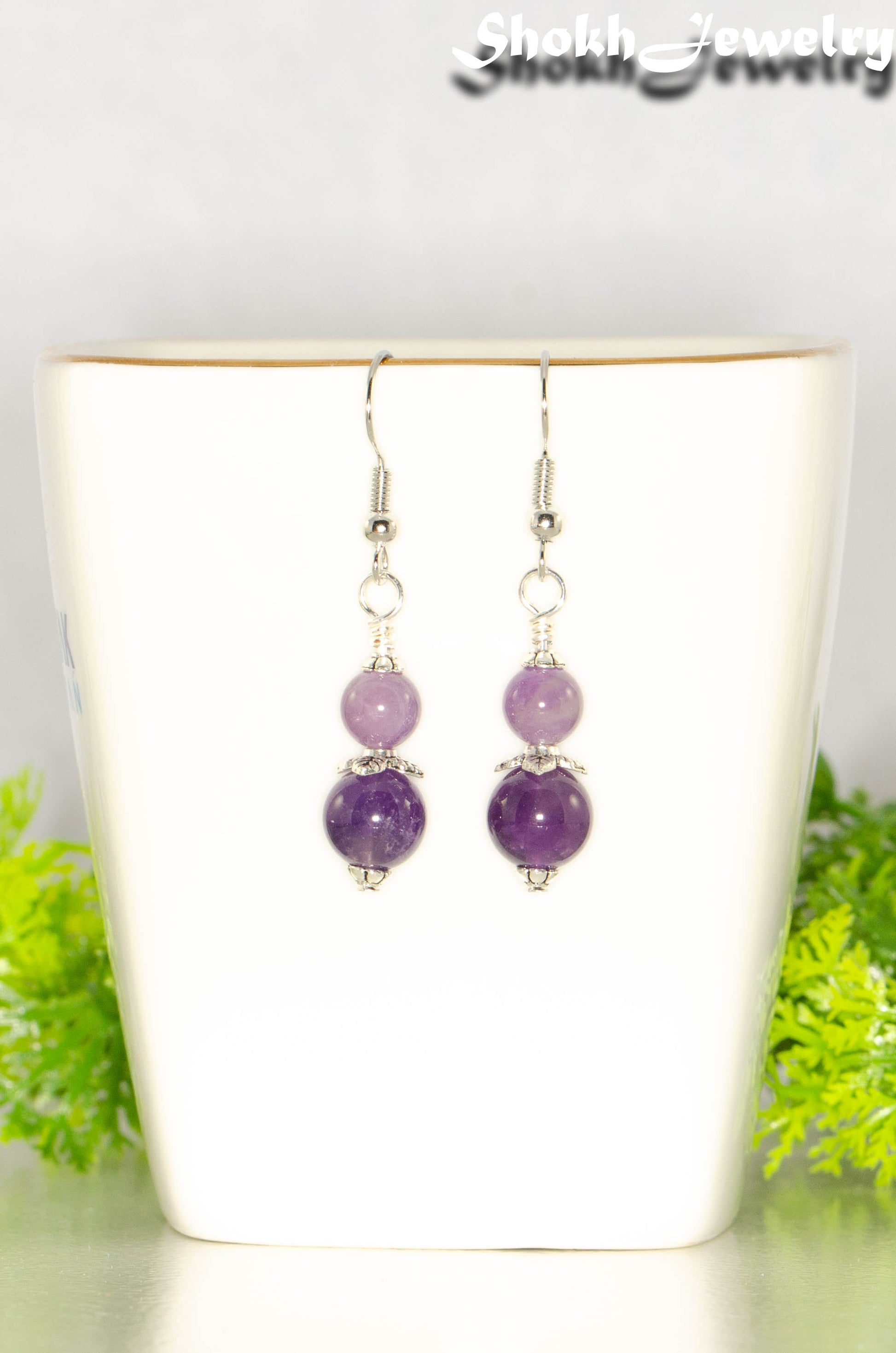 Small Natural Amethyst Crystal Earrings on a tea cup