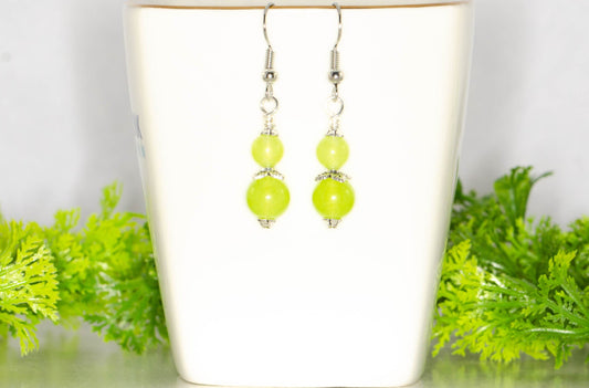 Small Natural Peridot Crystal Earrings on a tea cup