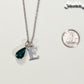 Personalized May Birthstone Pendant beside a dime