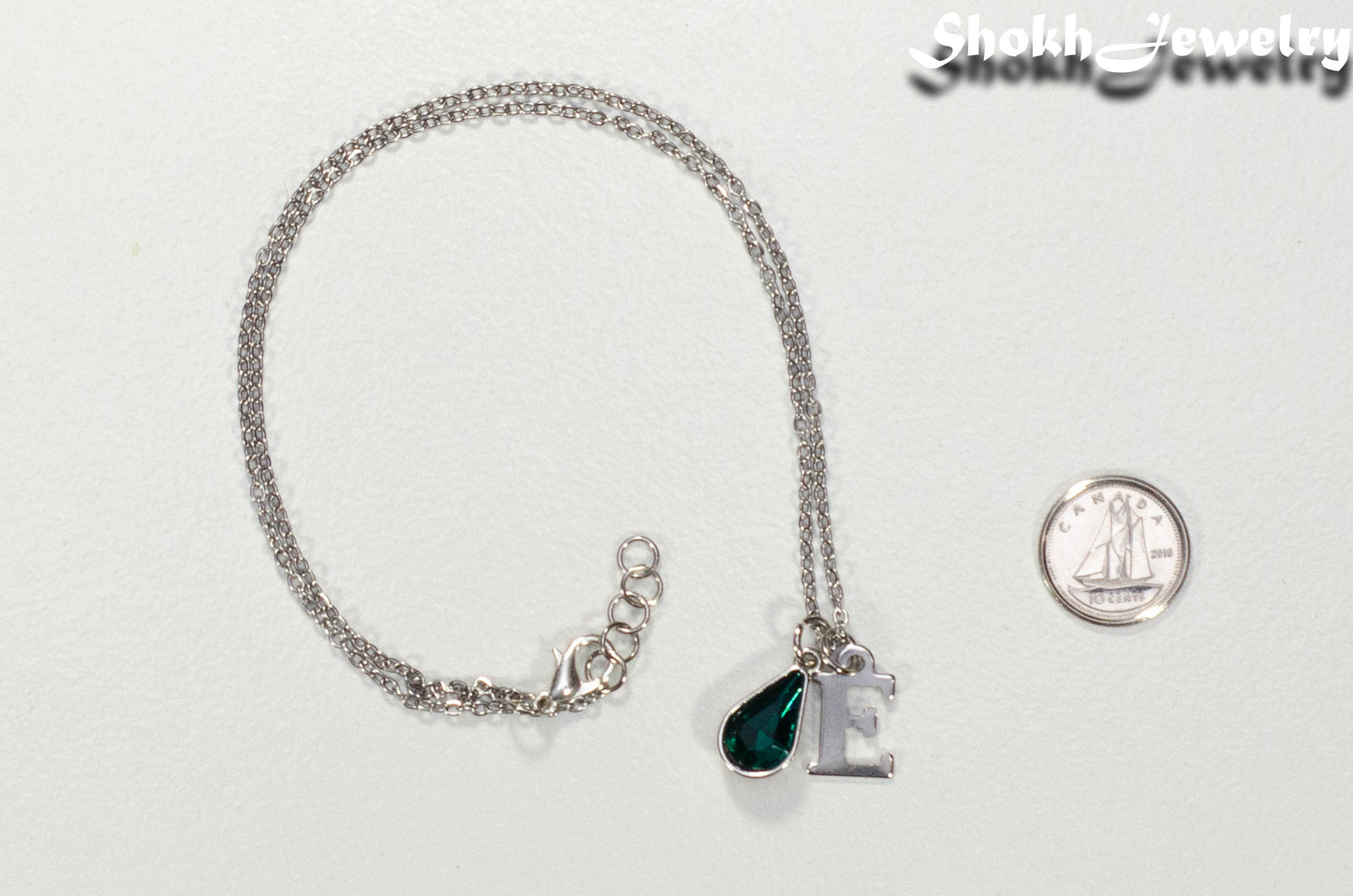 Personalized May Birthstone Choker Necklace beside a dime