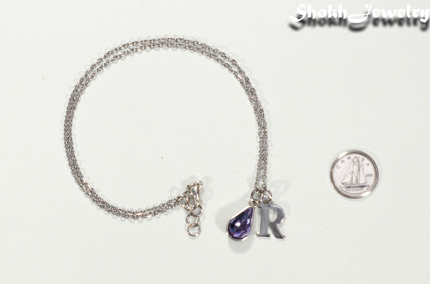 Personalized June Birthstone Choker Necklace beside a dime