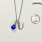 Personalized September Birthstone pendant beside a dime