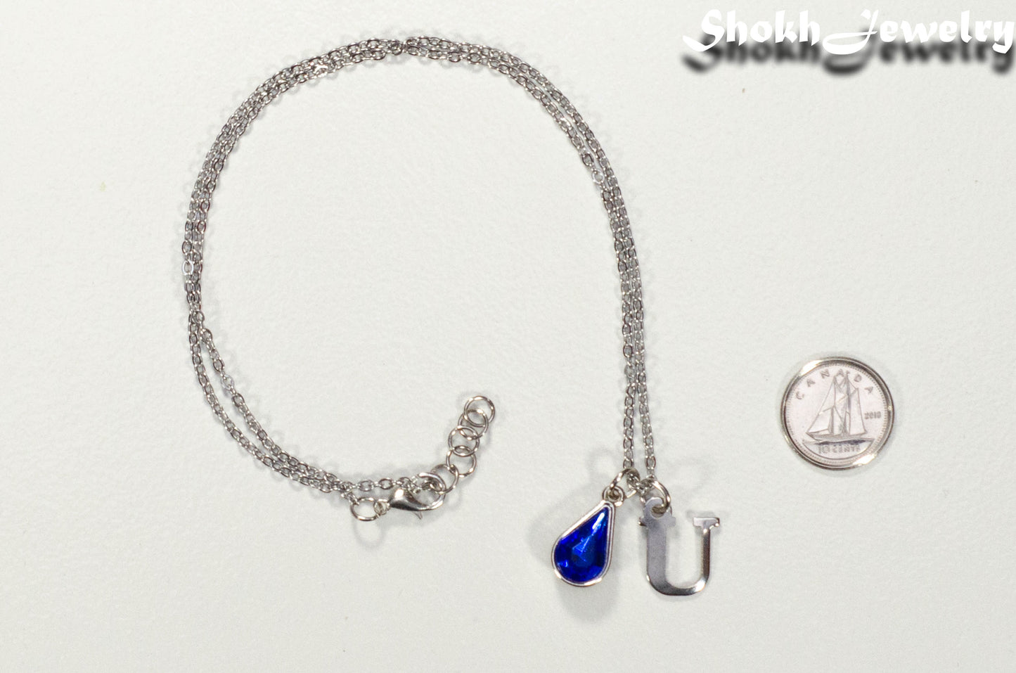 Personalized September Birthstone Choker Necklace beside a dime