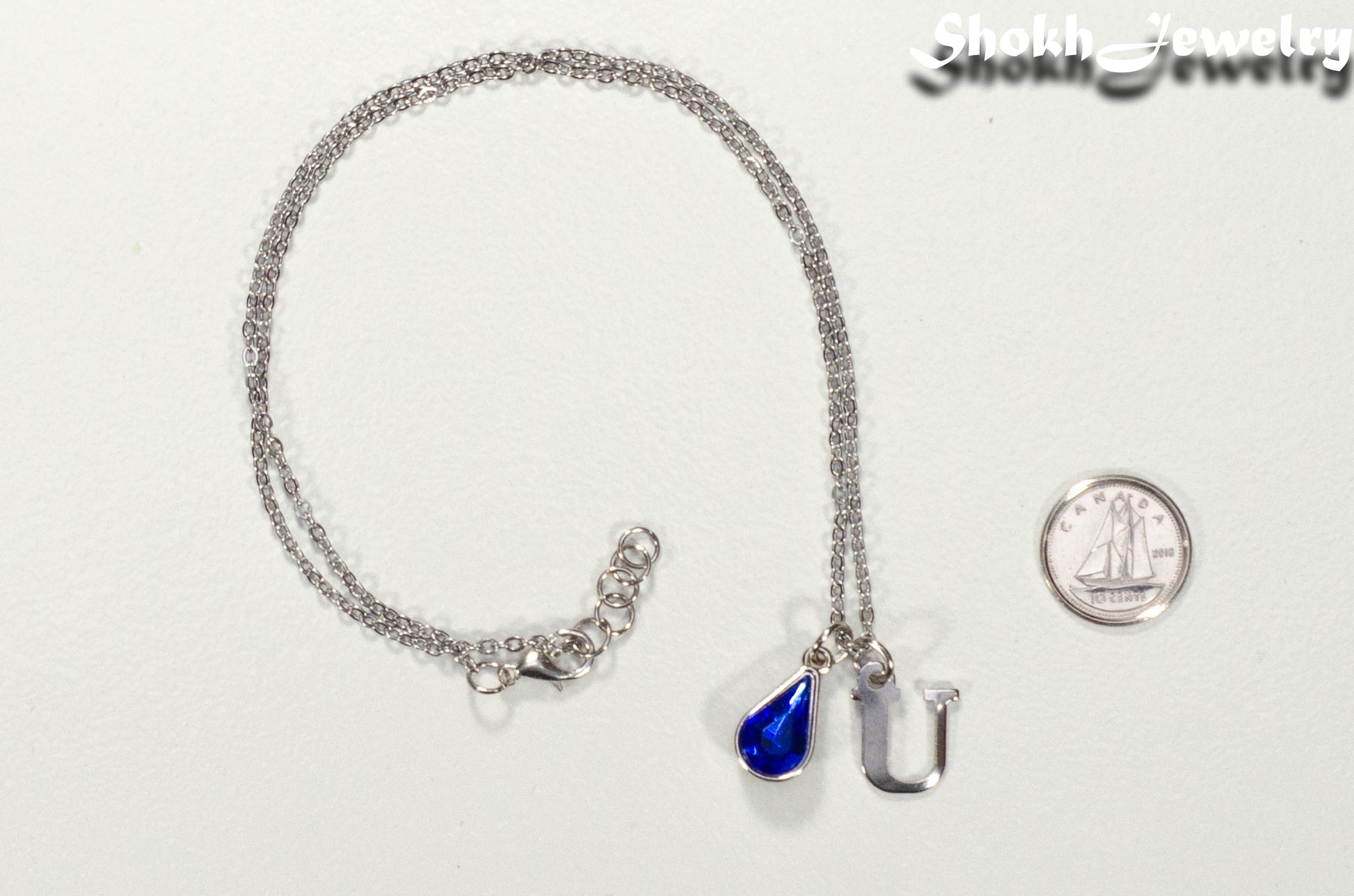 Personalized September Birthstone Choker Necklace beside a dime