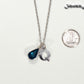 Personalized December Birthstone pendant beside a dime