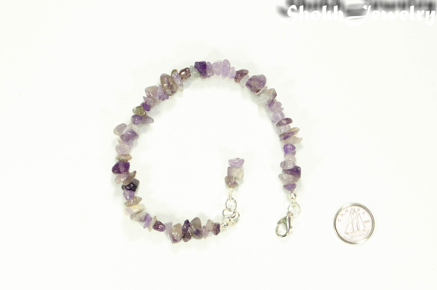 Natural Amethyst Crystal Chip Bracelet beside a dime