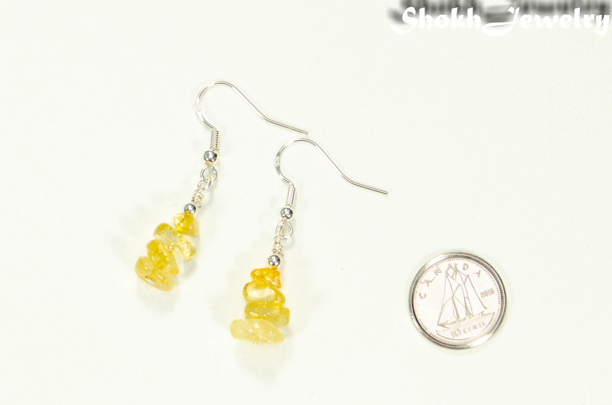 Simple Citrine Crystal Chip Earrings beside a dime.