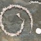 Natural Rose Quartz Crystal Chip Choker Necklace beside a dime