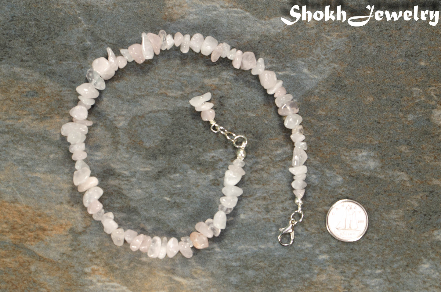 Natural Rose Quartz Crystal Chip Anklet beside a dime.