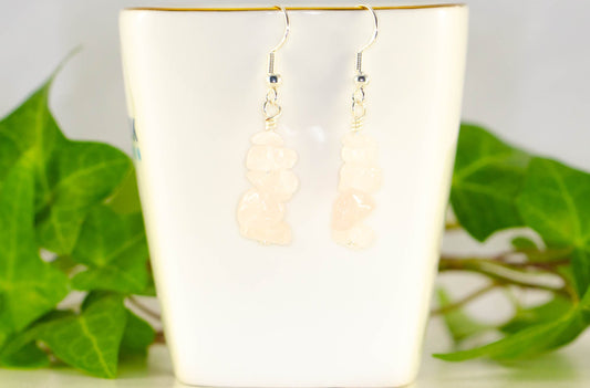Simple Rose Quartz Crystal Chip Earrings displayed on a tea cup.