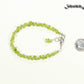 Natural Peridot Crystal Chip Bracelet beside a dime