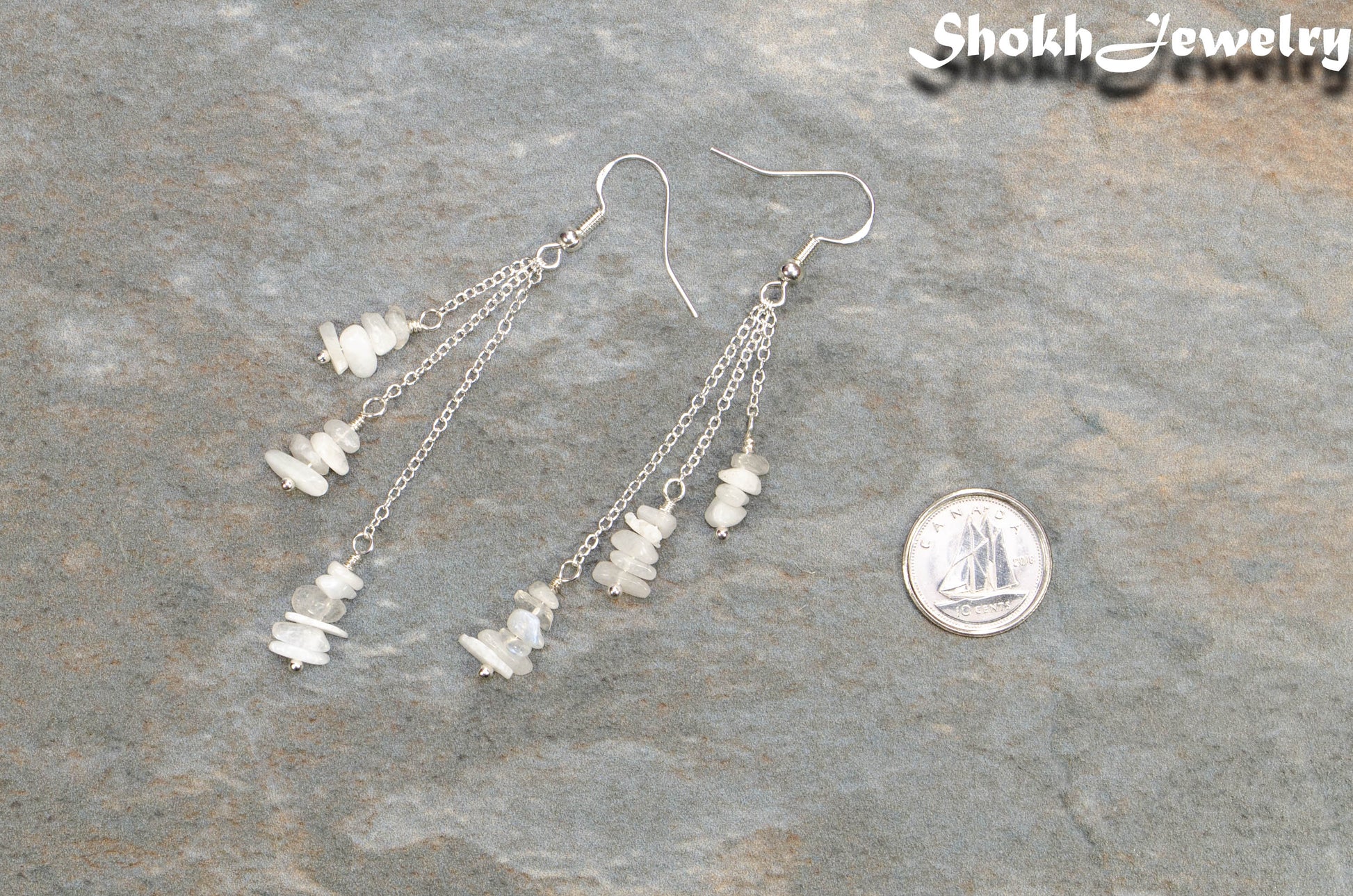 Long Silver Plated Chain and Moonstone Chip Earrings beside a dime