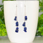 Long Silver Plated Chain and Lapis Lazuli Chip Earrings on a coffee mug