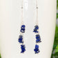 Long Silver Plated Chain and Lapis Lazuli Chip Earrings on a mug