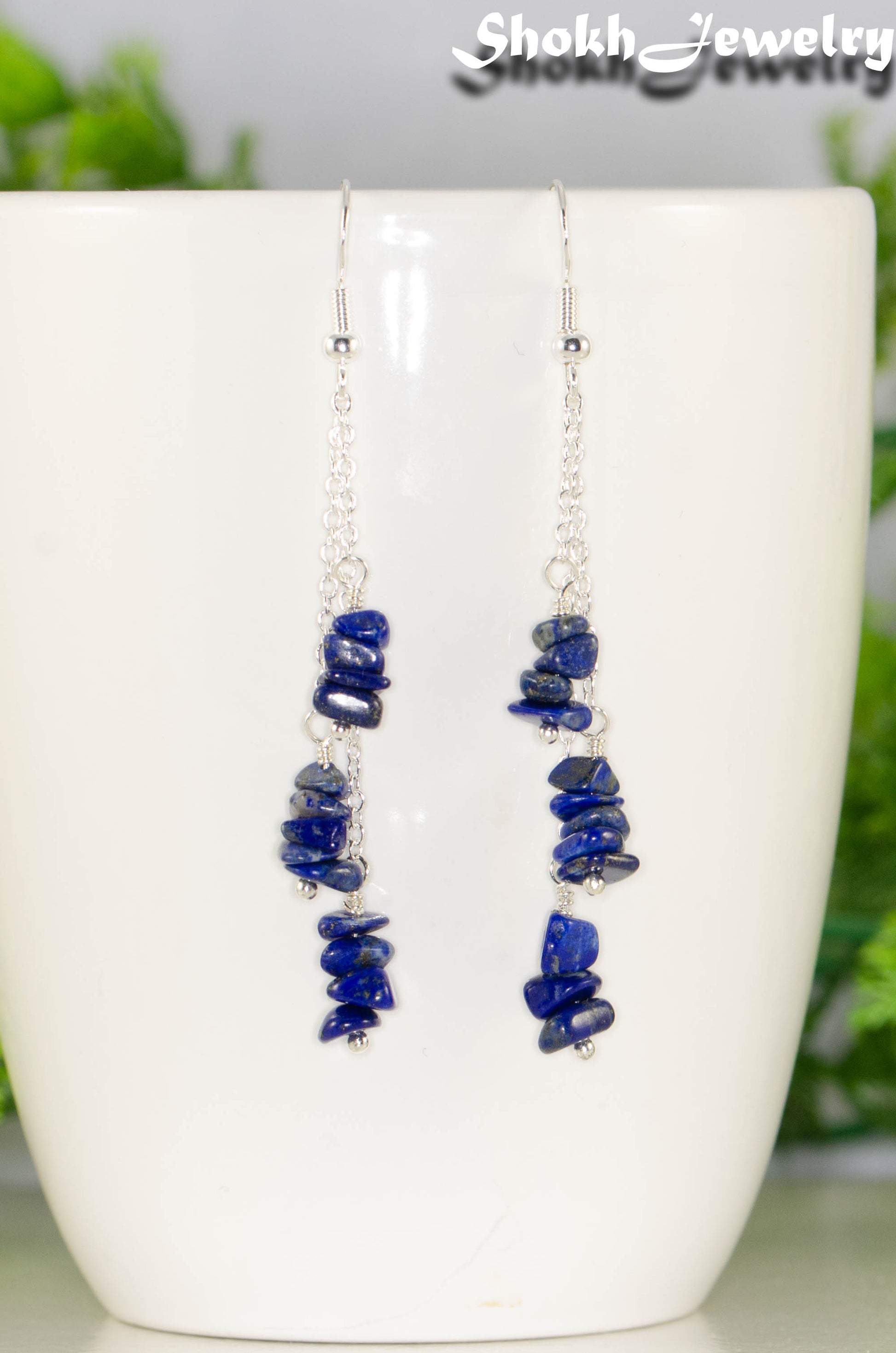 Long Silver Plated Chain and Lapis Lazuli Chip Earrings on a mug