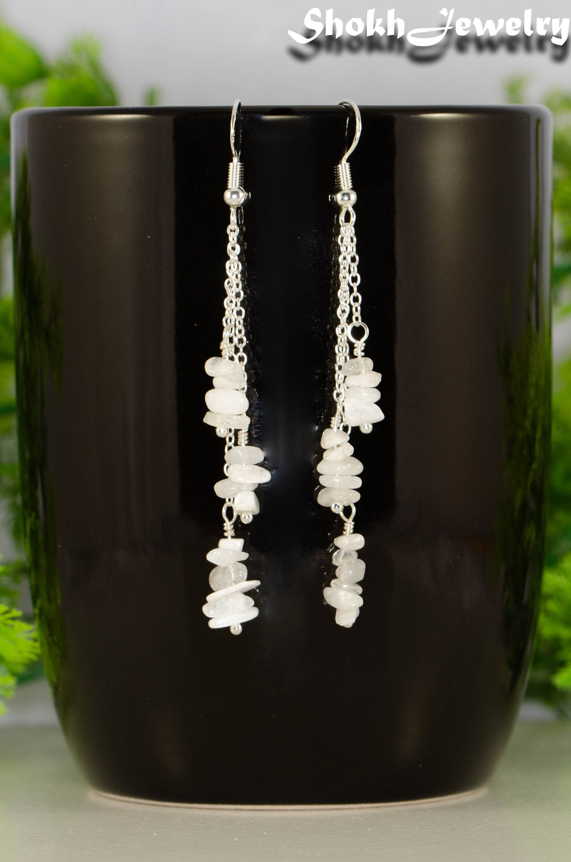Long Silver Plated Chain and Moonstone Chip Earrings on a mug