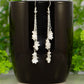 Long Silver Plated Chain and Moonstone Chip Earrings on a coffee mug