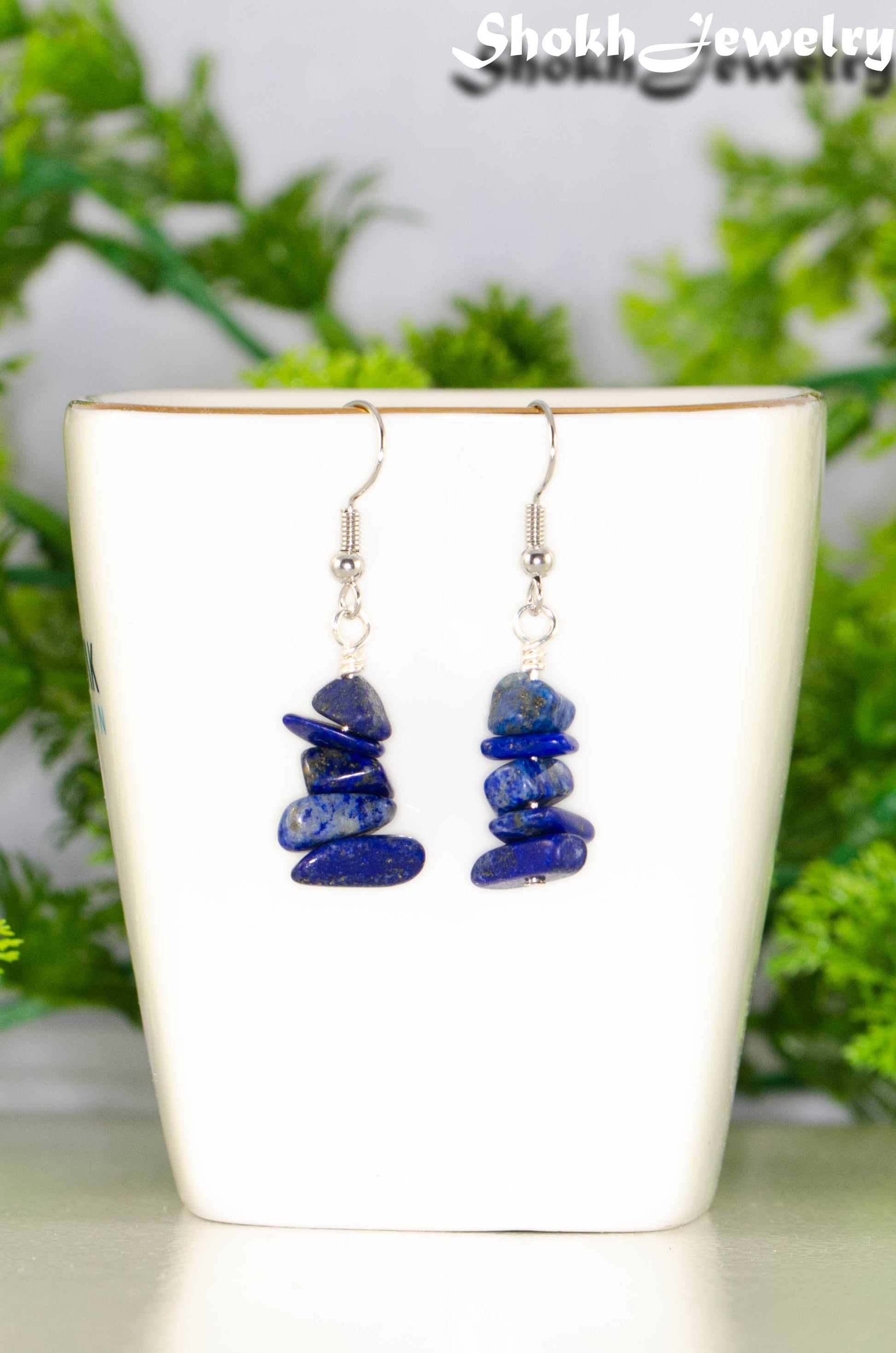 Simple Lapis Lazuli Crystal Chip Earrings displayed on a tea cup.