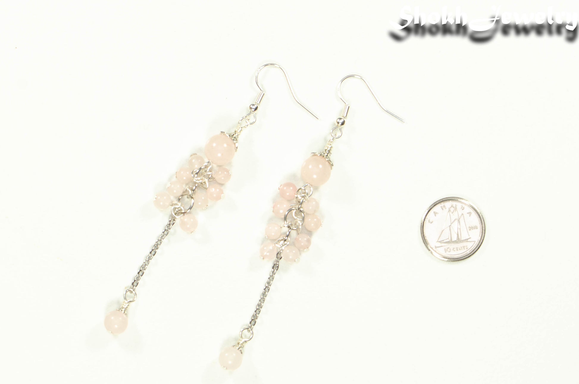 Long Stainless Steel Chain and Rose Quartz Earrings beside a dime.