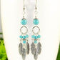 Close up of Statement Turquoise Howlite And Feather Earrings.