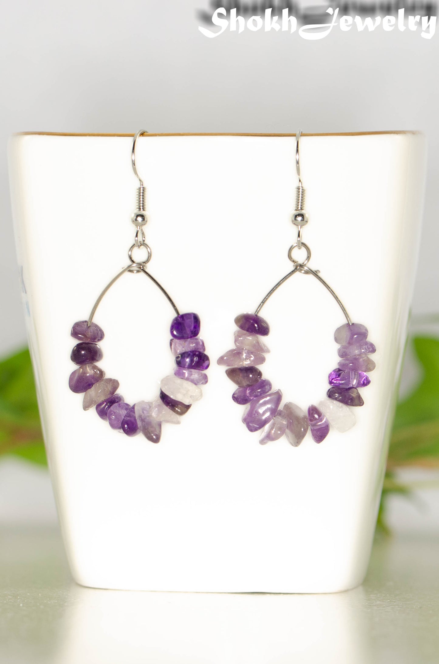 Natural Amethyst Crystal Chip Earrings on a tea cup