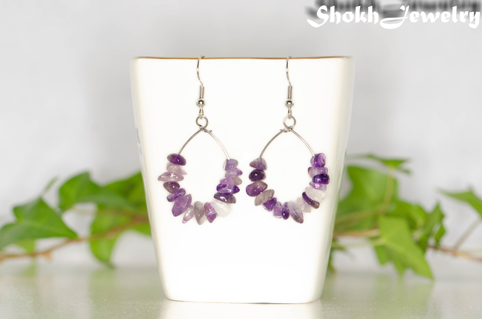 Natural Amethyst Crystal Chip Earrings on a tea cup