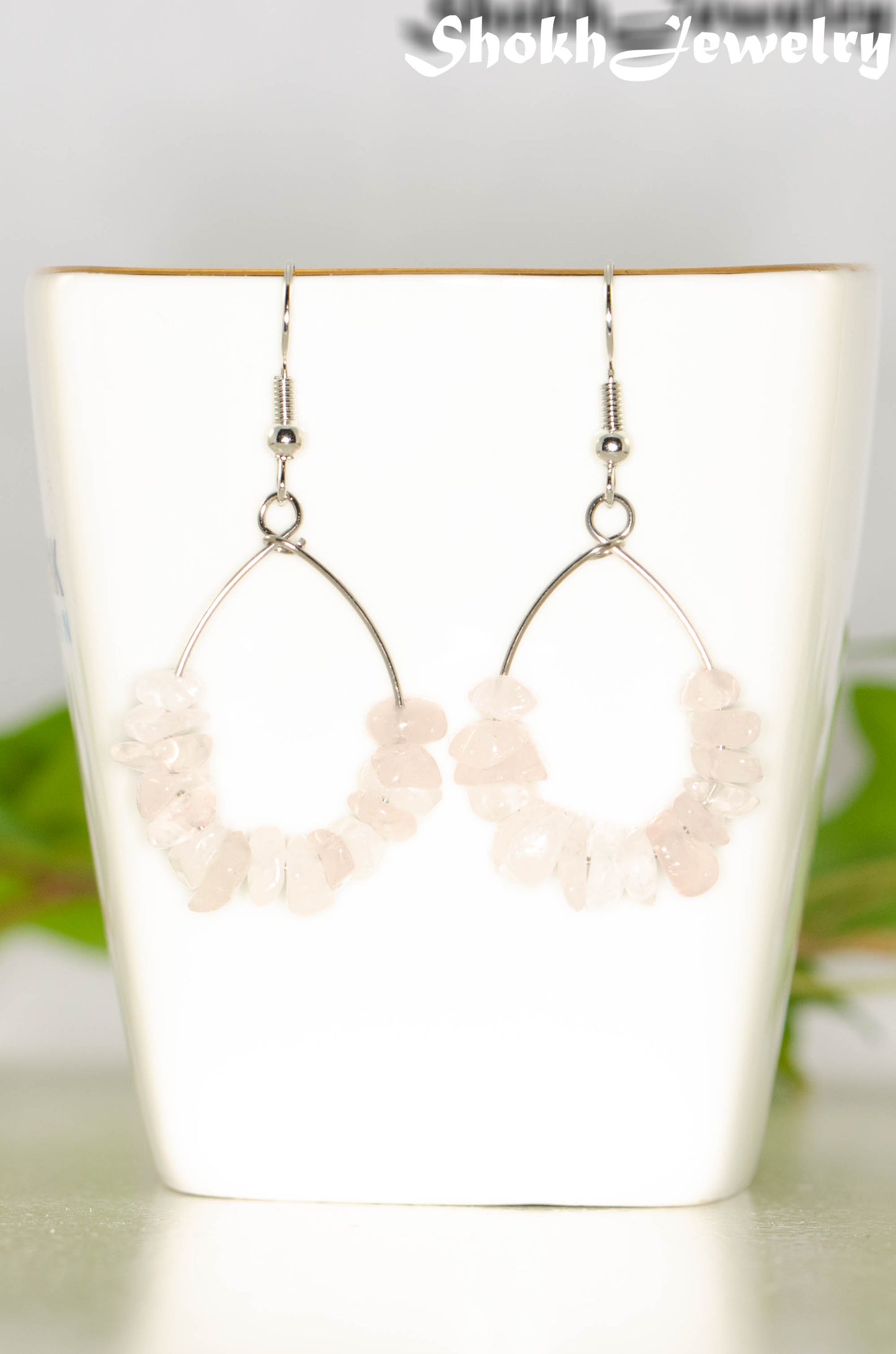 Natural Rose Quartz Crystal Chip Earrings on a tea cup