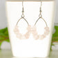 Natural Rose Quartz Crystal Chip Earrings on a tea cup