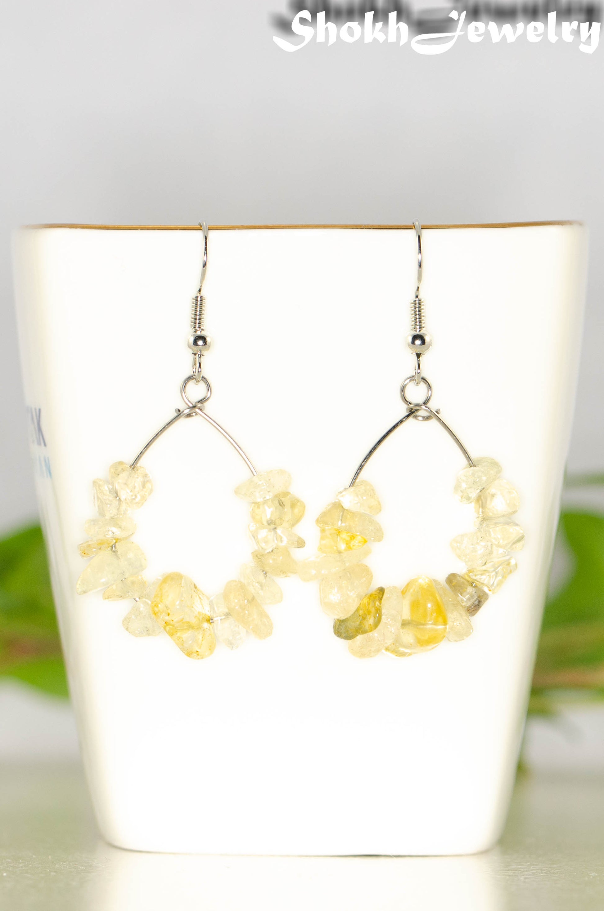 Natural Citrine Crystal Chip Earrings on a tea cup