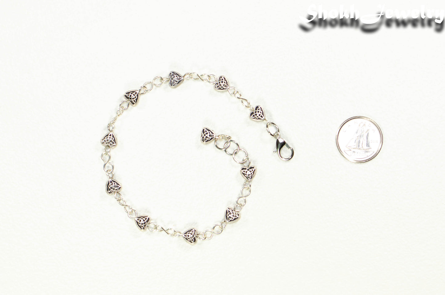 Tibetan Silver Heart Anklet beside a dime.